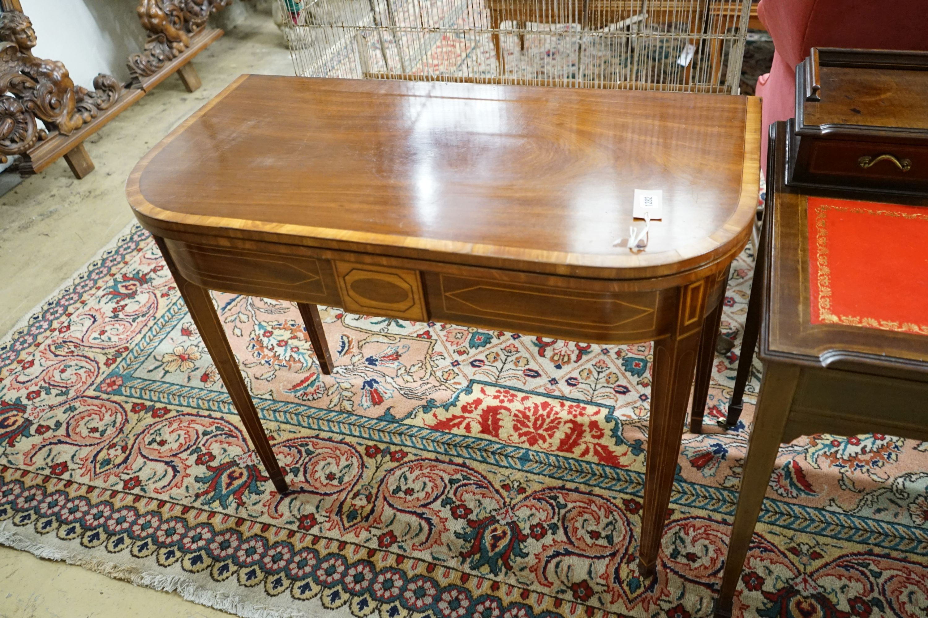 A George III satinwood banded mahogany D shaped folding tea table, width 94cm, depth 48cm, height 75cm